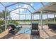 Beautiful screened lanai with comfortable seating and a scenic lake view; ideal for outdoor relaxation at 1920 Iglesia St, The Villages, FL 32159