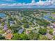An aerial view of a community with many houses, trees, and ponds in a serene setting at 206 Palermo Pl, Lady Lake, FL 32159
