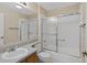 Bathroom with tub-shower featuring tiled walls, glass door and vanity with solid surface counter top at 206 Palermo Pl, Lady Lake, FL 32159