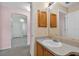 This bathroom features a vanity with cabinet storage, tiled walls and mirror at 206 Palermo Pl, Lady Lake, FL 32159