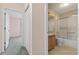 This bathroom features a shower-tub combo with sliding glass doors and wallpapered accents at 206 Palermo Pl, Lady Lake, FL 32159