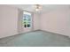 Bedroom features neutral walls, a large window and neutral curtains letting in light at 206 Palermo Pl, Lady Lake, FL 32159