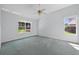 Spacious bedroom with bright, white walls, ceiling fan and large double hung windows at 206 Palermo Pl, Lady Lake, FL 32159