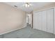 Bedroom features a ceiling fan, closet and hallway entrance at 206 Palermo Pl, Lady Lake, FL 32159