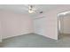 Bedroom with neutral walls, carpet, ceiling fan, closet and entrance to another room at 206 Palermo Pl, Lady Lake, FL 32159