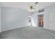 Large main bedroom with soft blue walls, ceiling fan and en-suite bathroom at 206 Palermo Pl, Lady Lake, FL 32159