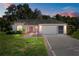 Charming single-story home with manicured lawn, mature landscaping, and side entry two car garage at 206 Palermo Pl, Lady Lake, FL 32159