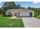 Charming one-story home featuring an attached garage and well-maintained landscaping at 206 Palermo Pl, Lady Lake, FL 32159