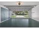 Two car garage with epoxy flooring, and built-in storage space; door is open to the street at 206 Palermo Pl, Lady Lake, FL 32159