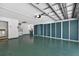 Spacious two car garage with epoxy flooring, storage, and laundry hookups at 206 Palermo Pl, Lady Lake, FL 32159