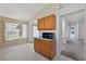 Kitchen breakfast nook showcases wood cabinets, microwave, pendant light and a view to the hallway at 206 Palermo Pl, Lady Lake, FL 32159