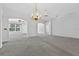 Spacious living room offering ample natural light, neutral tones, and chandelier at 206 Palermo Pl, Lady Lake, FL 32159