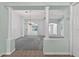 Open living room featuring high ceilings, decorative columns, and views to the dining area at 206 Palermo Pl, Lady Lake, FL 32159