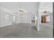 Bright living room with chandeliers, ceiling fans, and arched doorways to the home's other rooms at 206 Palermo Pl, Lady Lake, FL 32159