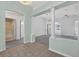 Open living room featuring high ceilings, decorative columns, and views to the bathroom at 206 Palermo Pl, Lady Lake, FL 32159