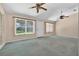 Living room featuring large windows with backyard view and ceiling fan at 206 Palermo Pl, Lady Lake, FL 32159
