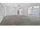 Bright living room with chandelier, ceiling fan, and arched doorways to the home's other rooms at 206 Palermo Pl, Lady Lake, FL 32159