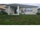 Backyard view featuring a covered patio, lawn, and sliding glass door at 222 Bacopa Pass, Davenport, FL 33897