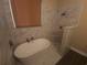 Modern bathroom showcasing a soaking tub, walk-in shower, and elegant tiling at 222 Bacopa Pass, Davenport, FL 33897