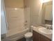 Bathroom with a tub-shower combo, vanity sink, and toilet at 222 Bacopa Pass, Davenport, FL 33897