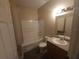 Bathroom with a tub-shower combo, vanity sink, and toilet at 222 Bacopa Pass, Davenport, FL 33897
