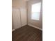Bedroom featuring wood-look floors, sliding closet, and a window at 222 Bacopa Pass, Davenport, FL 33897