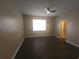 Spacious bedroom with wood-look floors, a ceiling fan, and an ensuite bathroom at 222 Bacopa Pass, Davenport, FL 33897