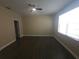 Bright bedroom with modern ceiling fan, neutral paint, and dark wood-look floors at 222 Bacopa Pass, Davenport, FL 33897