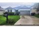 Charming single-Gathering home with a well-manicured lawn and a two-car garage at 222 Bacopa Pass, Davenport, FL 33897