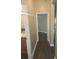 Hallway with wood-look floors leading into bedroom and bathroom at 222 Bacopa Pass, Davenport, FL 33897