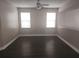 Open-concept living room featuring sleek flooring and a modern ceiling fan at 222 Bacopa Pass, Davenport, FL 33897