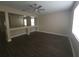 Living room with dark wood-look floors, cut-out wall feature, and lots of light at 222 Bacopa Pass, Davenport, FL 33897