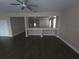 Open concept living room with dark wood-look floors and lots of light. Cut out wall feature at 222 Bacopa Pass, Davenport, FL 33897