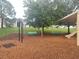 Community playground with swings, a slide, mulch ground cover, and park benches at 222 Bacopa Pass, Davenport, FL 33897