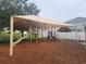 Community playground featuring a slide, climbing structures, and a shaded canopy at 222 Bacopa Pass, Davenport, FL 33897