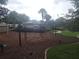 Community playground with mulch ground cover, swings, and lush landscaping at 222 Bacopa Pass, Davenport, FL 33897