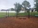 Community playground with swings, seating, and mulch ground cover at 222 Bacopa Pass, Davenport, FL 33897