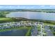 Aerial view of a residential neighborhood next to a lake, showcasing the community's layout and natural surroundings at 2330 Nuthatch St, St Cloud, FL 34771