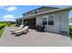 Beautiful backyard featuring brick patio, lounge chairs, and outdoor grill at 2330 Nuthatch St, St Cloud, FL 34771