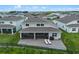Aerial view of backyard featuring screened lanai, patio with lounge chairs and barbecue at 2330 Nuthatch St, St Cloud, FL 34771