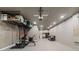 Finished basement with gym equipment, storage shelves, and cozy seating area at 2330 Nuthatch St, St Cloud, FL 34771