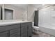 Well-lit bathroom featuring a modern vanity with drawers, a mirror, a toilet, and a shower with a curtain at 2330 Nuthatch St, St Cloud, FL 34771
