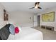 Bright bedroom featuring a neutral color scheme, decorative pillows, and a large map on the wall at 2330 Nuthatch St, St Cloud, FL 34771