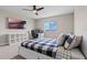 Bright bedroom featuring a ceiling fan, a desk, a large window with a scenic view and a television at 2330 Nuthatch St, St Cloud, FL 34771
