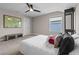 Bright bedroom showcasing a world map, a ceiling fan, and a window providing natural light and a view at 2330 Nuthatch St, St Cloud, FL 34771