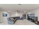 Spacious living area with comfortable seating, large-screen TV, and custom shelving at 2330 Nuthatch St, St Cloud, FL 34771