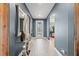Inviting entryway with decorative mirror, glass table, and a view into the home at 2330 Nuthatch St, St Cloud, FL 34771