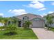 Well maintained single-story home with a manicured lawn, and a paver driveway at 2330 Nuthatch St, St Cloud, FL 34771