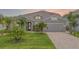 Beautiful single-story home with well-manicured lawn, palm trees, and a two-car garage at 2330 Nuthatch St, St Cloud, FL 34771