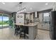 Stylish kitchen boasting granite countertops, stainless steel appliances, an island with seating, and pendant lighting at 2330 Nuthatch St, St Cloud, FL 34771